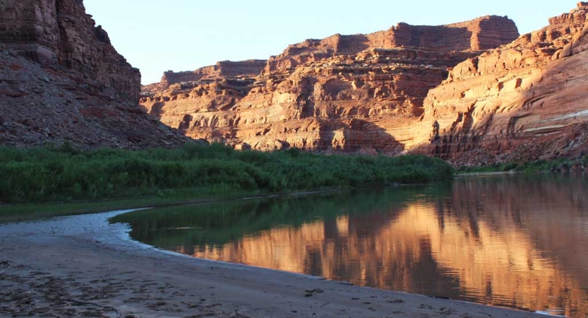 A river winds through red canyon walls